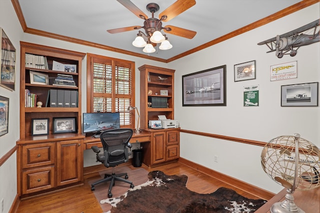 office space featuring wood finished floors, ceiling fan, baseboards, and ornamental molding