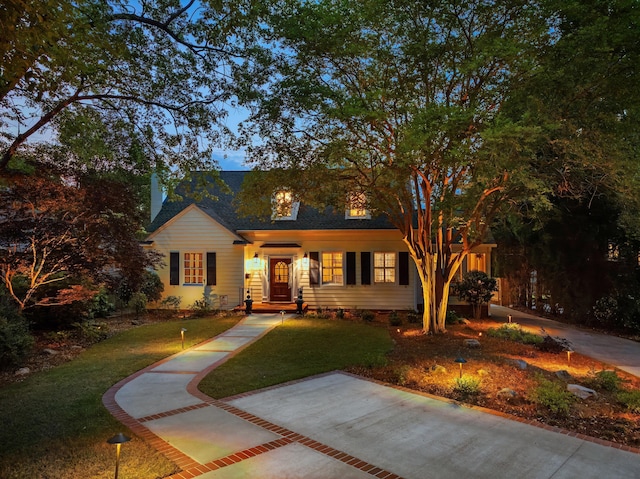 view of front of home with a front yard and roof with shingles