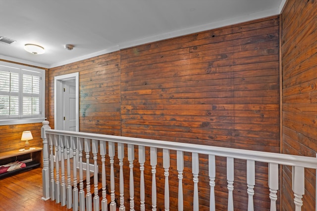 hallway with wooden walls and wood finished floors