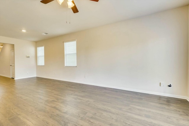 unfurnished room with hardwood / wood-style flooring and ceiling fan