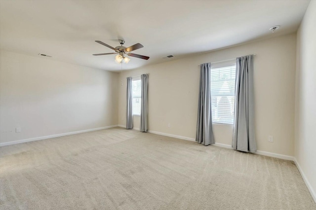 carpeted spare room with ceiling fan