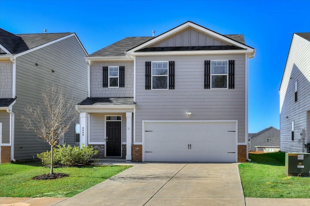 view of front of home featuring a front lawn and a garage