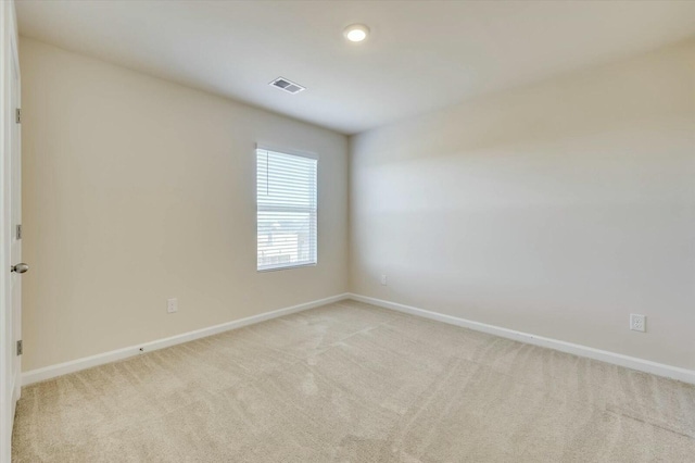 empty room with light colored carpet