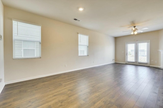 spare room featuring ceiling fan and dark hardwood / wood-style floors