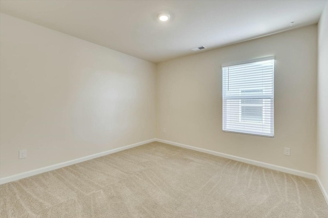 empty room with light colored carpet