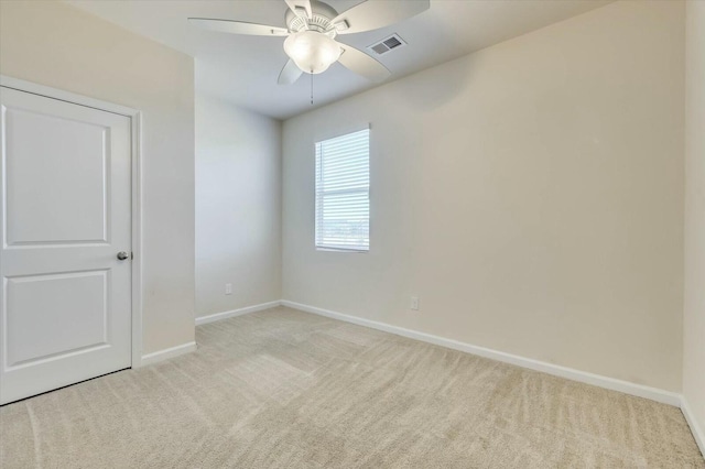 carpeted empty room featuring ceiling fan