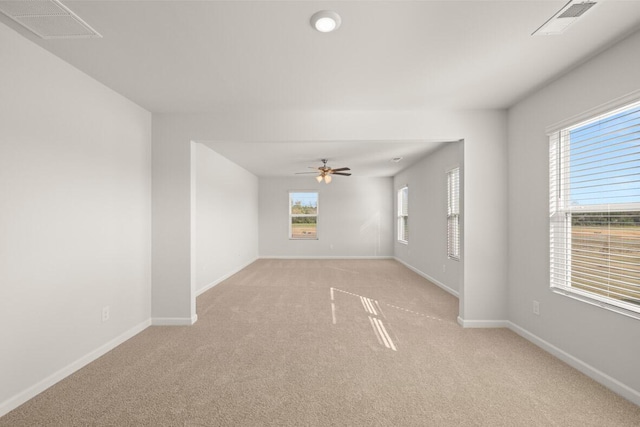 carpeted spare room with ceiling fan