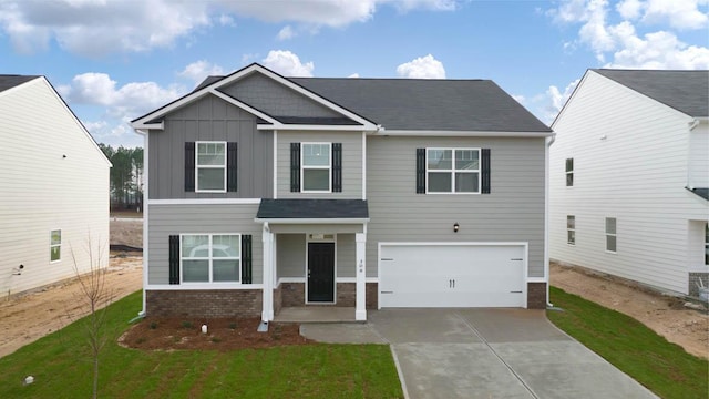 view of front of home featuring a front yard and a garage