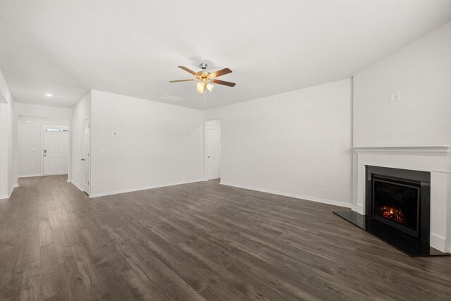 unfurnished living room featuring dark hardwood / wood-style floors and ceiling fan