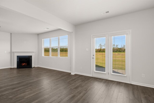 unfurnished living room featuring dark hardwood / wood-style floors