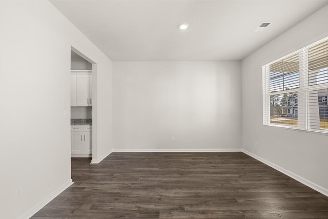 spare room featuring dark hardwood / wood-style floors