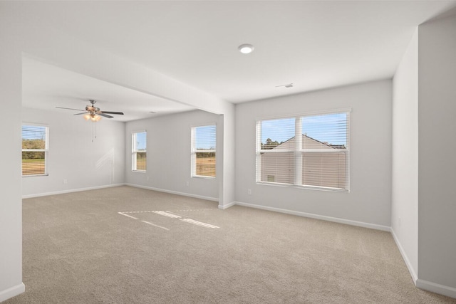 carpeted empty room featuring ceiling fan