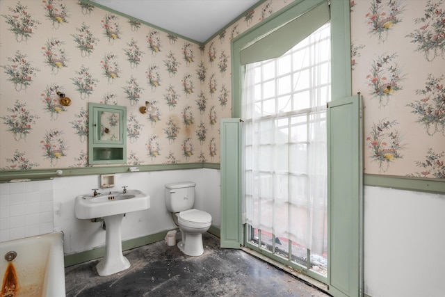 2131 Gardner St, Augusta, GA 30904 - bathroom featuring toilet, wallpapered walls, a tub, and ornamental molding