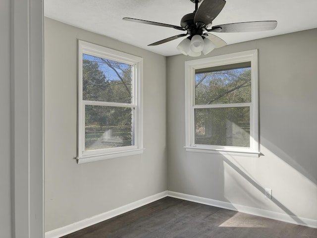 spare room with ceiling fan and dark hardwood / wood-style floors