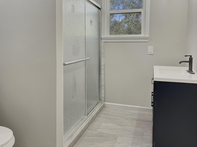 bathroom with vanity, toilet, and walk in shower