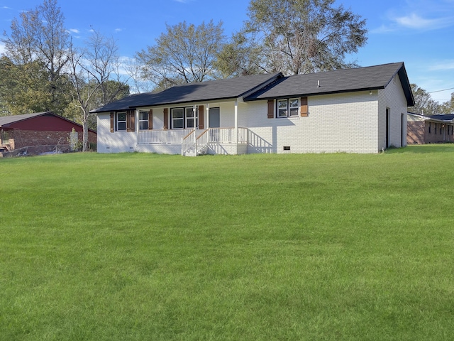 rear view of property with a porch and a yard