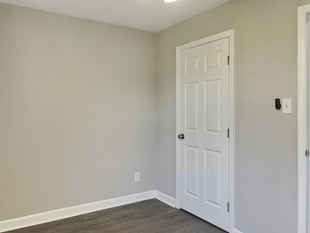 unfurnished room with dark hardwood / wood-style floors