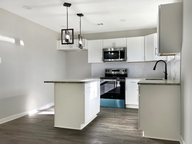 kitchen featuring a kitchen island, white cabinetry, sink, and appliances with stainless steel finishes