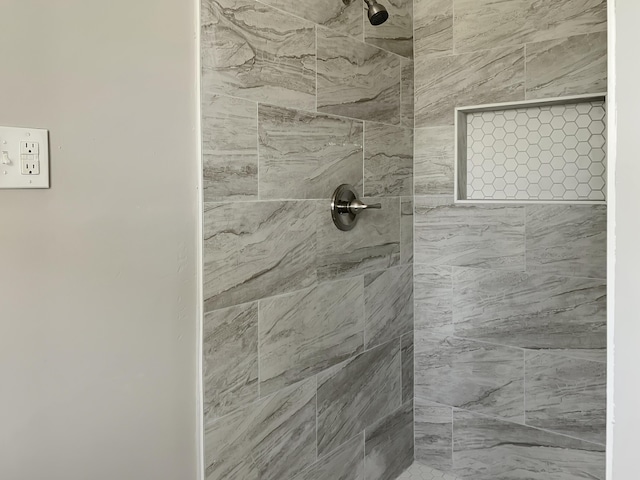 bathroom with a tile shower