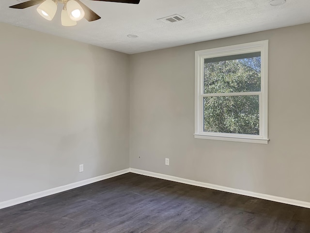 spare room with dark hardwood / wood-style floors, ceiling fan, a textured ceiling, and a wealth of natural light