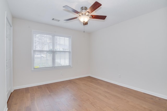 spare room with ceiling fan and light wood-type flooring