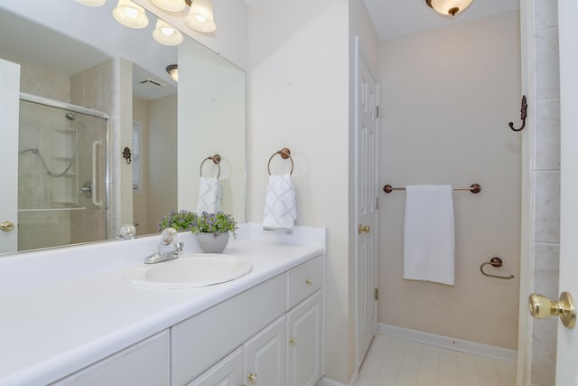 bathroom with an enclosed shower and vanity