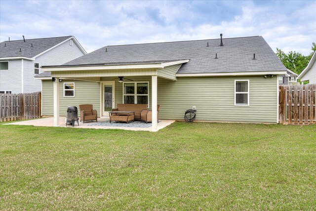 rear view of property with a lawn, a patio, ceiling fan, and a fenced backyard