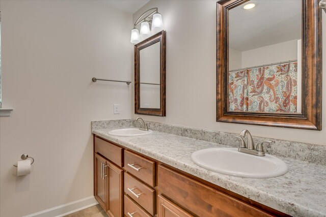 bathroom featuring double vanity and a sink