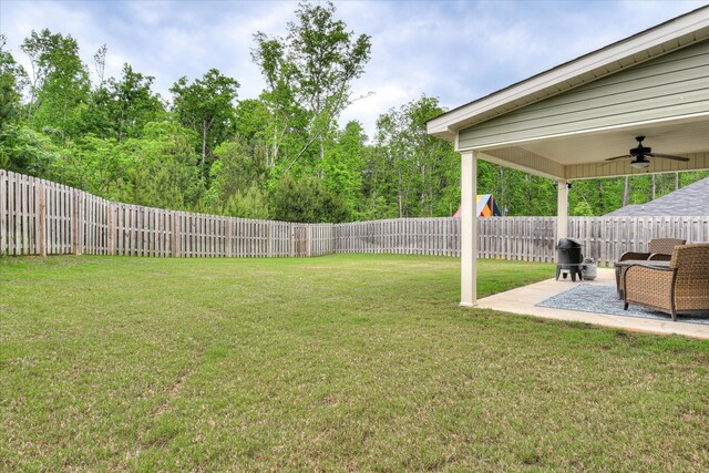 view of yard with a patio, a ceiling fan, and a fenced backyard