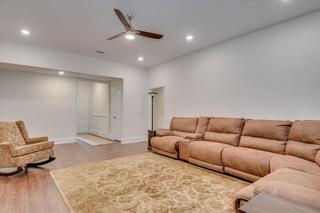 living room with a ceiling fan, baseboards, recessed lighting, and wood finished floors