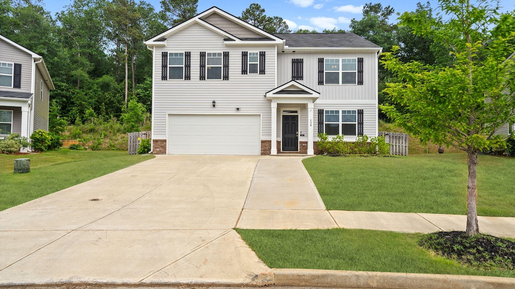 135 Lookout Loop, North Augusta, SC 29841 - view of front of home with an attached garage, driveway, a front lawn, board and batten siding, and brick siding