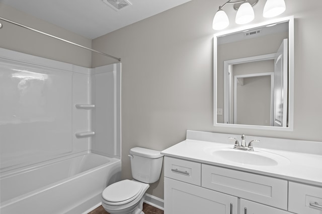 full bathroom featuring washtub / shower combination, vanity, and toilet