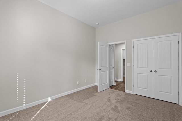 unfurnished bedroom with carpet floors and a closet