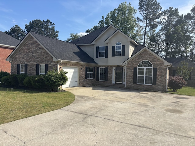 view of front of house featuring roof with shingles, concrete driveway, brick siding, an attached garage, and a front yard