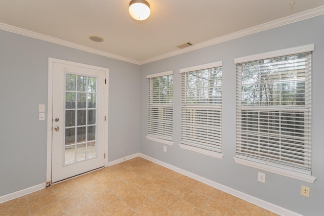 unfurnished room with baseboards, crown molding, and visible vents