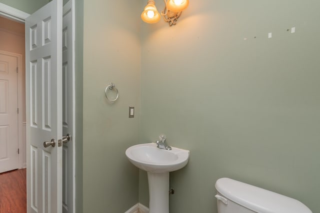 bathroom with wood finished floors and toilet