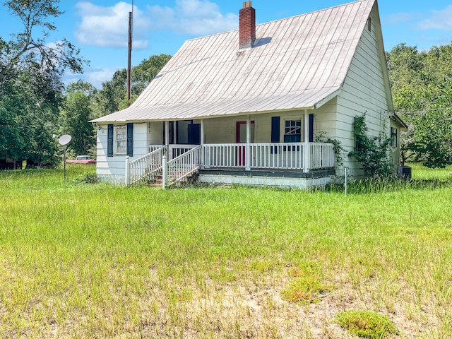 5639 Purvis School Rd, Stapleton, GA 30823 - view of front of home featuring covered porch, a chimney, and a metal roof
