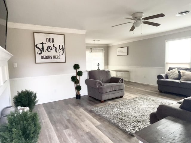 living room with ceiling fan, wood-type flooring, and crown molding