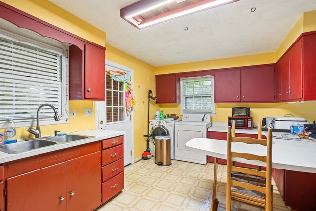 102 Briarcliff St, Belvedere, SC 29841 - kitchen with washer and dryer, light floors, red cabinetry, and light countertops