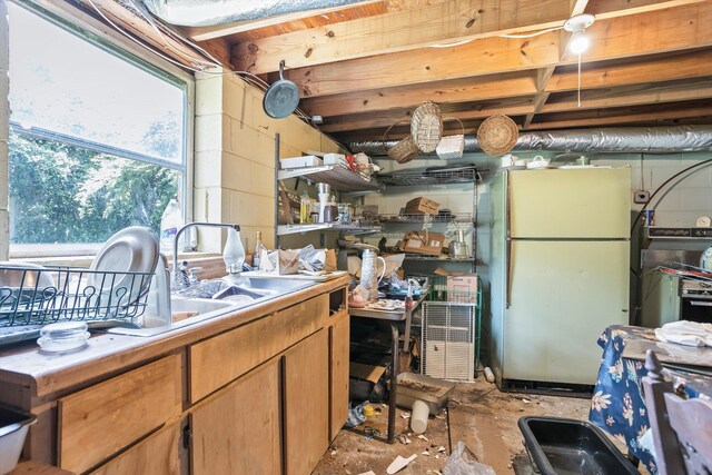 102 Briarcliff St, Belvedere, SC 29841 - kitchen featuring freestanding refrigerator, concrete floors, and concrete block wall