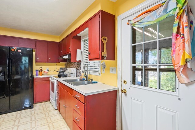 102 Briarcliff St, Belvedere, SC 29841 - kitchen with black refrigerator with ice dispenser, electric stove, under cabinet range hood, light flooring, and red cabinets