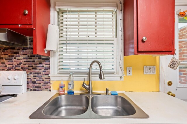 102 Briarcliff St, Belvedere, SC 29841 - kitchen featuring tasteful backsplash, red cabinetry, healthy amount of natural light, and extractor fan