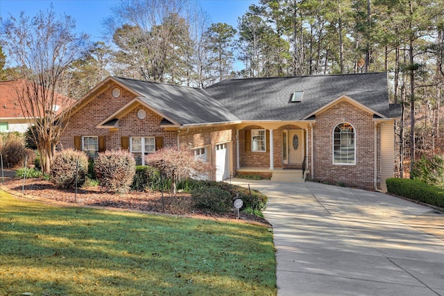 view of front of house featuring driveway, an attached garage, a shingled roof, a front lawn, and brick siding