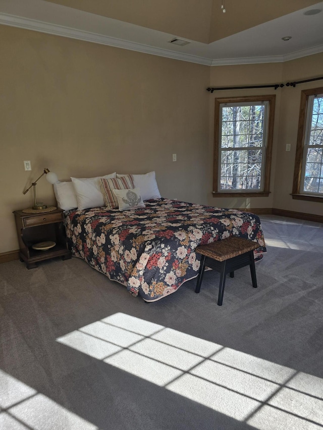 carpeted bedroom with visible vents, baseboards, and ornamental molding