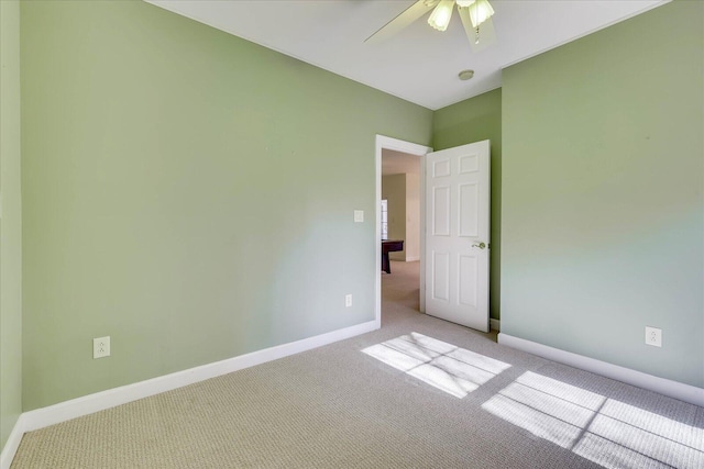 unfurnished room with baseboards, light carpet, and ceiling fan