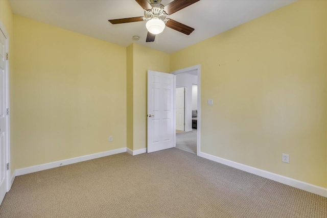 unfurnished bedroom featuring baseboards, light colored carpet, and ceiling fan