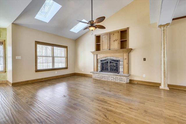 unfurnished living room featuring a brick fireplace, baseboards, ceiling fan, light wood-type flooring, and high vaulted ceiling