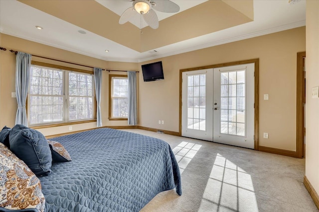 bedroom with access to exterior, french doors, light carpet, and a raised ceiling