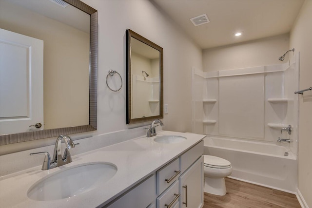 full bathroom featuring vanity,  shower combination, toilet, and wood-type flooring