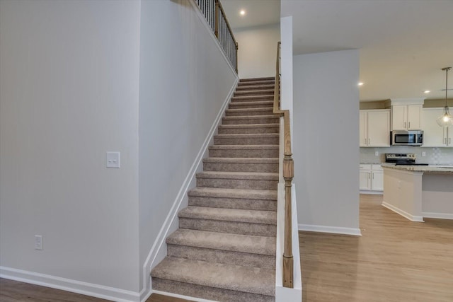 staircase featuring hardwood / wood-style flooring